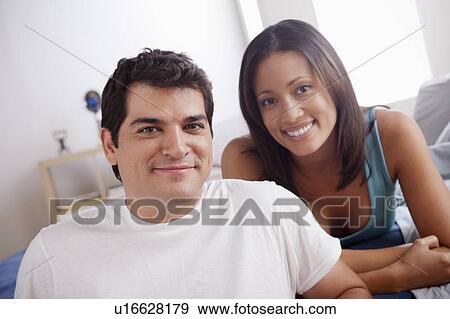 Portrait of mid adult couple in bedroom View Large Photo Image Stock Photo - Portrait of mid adult couple in bedroom. Fotosearch