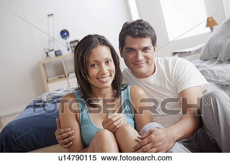 Portrait of mid adult couple sitting on bedroom floor View Large Photo Image Stock Photography - Portrait of mid adult couple sitting on bedroom floor. Fotosearch