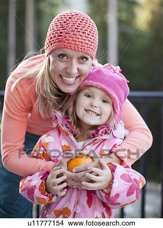 Portrait of mother and daughter (4-5) wearing warm clothing View Large Photo Image Picture - Portrait of mother and daughter (4-5) wearing warm clothing. Fotosearch