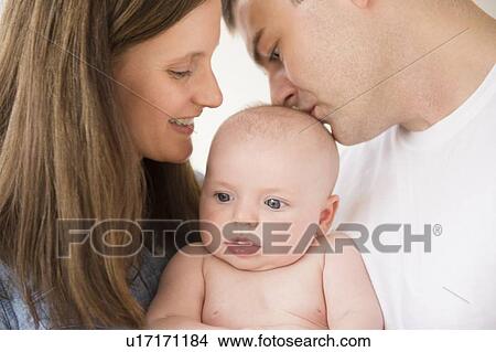 Picture - Portrait of parents with baby boy (2-5 months). Fotosearch