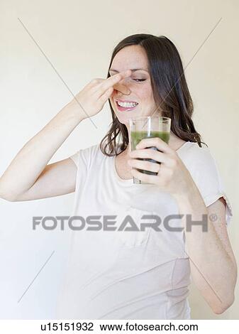Portrait of pregnant mid adult woman drinking green juice View Large Photo Image Stock Image - Portrait of pregnant mid adult woman drinking green juice. Fotosearch