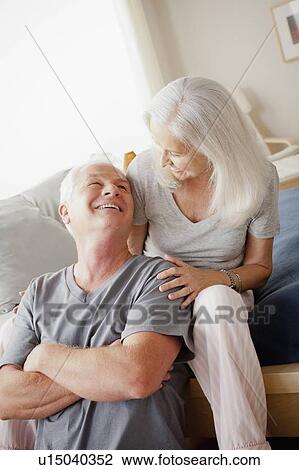 Stock Image - Portrait of senior couple in bedroom. Fotosearch