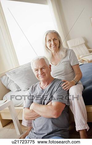 Stock Photography - Portrait of senior couple in bedroom. Fotosearch