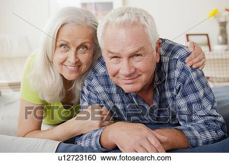 Portrait of senior couple laying on bed View Large Photo Image Stock Image - Portrait of senior couple laying on bed. Fotosearch