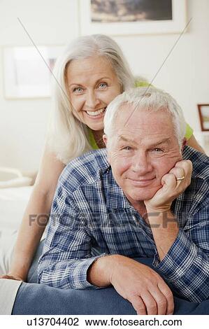 Portrait of senior couple laying on bed View Large Photo Image Stock Image - Portrait of senior couple laying on bed. Fotosearch