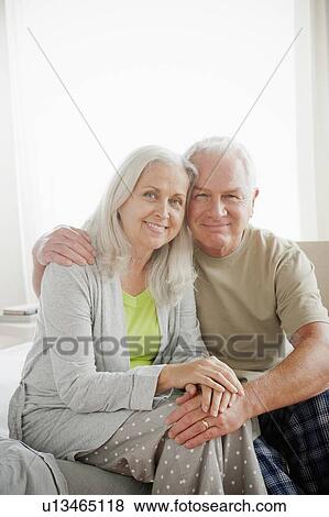 Portrait of senior couple sitting in bedroom View Large Photo Image Stock Photo - Portrait of senior couple sitting in bedroom. Fotosearch