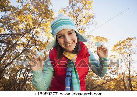 Portrait of smiling young woman in autumn forest View Large Photo Image Stock Photo - Portrait of smiling young woman in autumn forest. Fotosearch