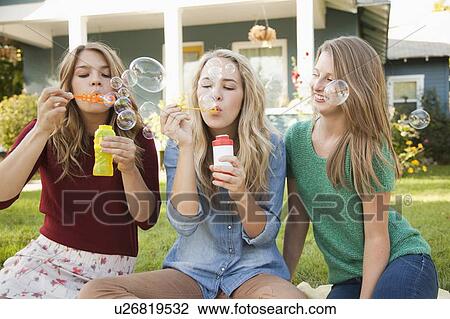 Portrait of three friends blowing bubbles View Large Photo Image Stock Image - Portrait of three friends blowing bubbles. Fotosearch