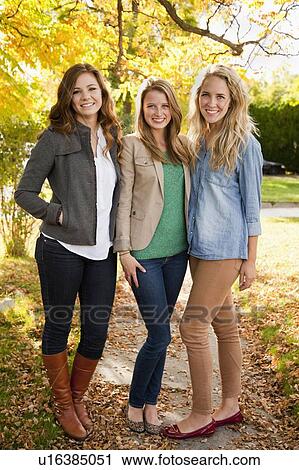 Portrait of three young women in autumn day View Large Photo Image Stock Image - Portrait of three young women in autumn day. Fotosearch