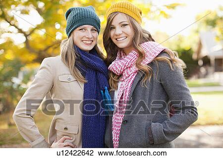 Portrait of two young women wearing hats and scarves View Large Photo Image Stock Image - Portrait of two young women wearing hats and scarves. Fotosearch