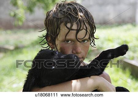 Portrait of wet Boy (10-11) with Labrador puppy View Large Photo Image Stock Image - Portrait of wet Boy (10-11) with Labrador puppy . Fotosearch