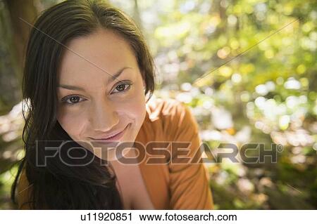 Stock Image - Portrait of woman in forest. Fotosearch