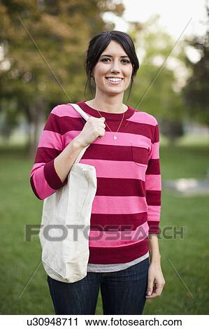 Portrait of woman in park View Large Photo Image Stock Image - Portrait of woman in park. Fotosearch