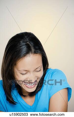 Stock Image - Portrait of woman laughing. Fotosearch