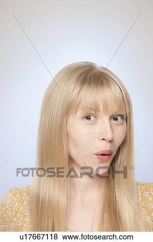 Stock Photo - Portrait of woman looking surprised. Fotosearch