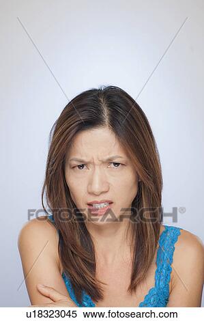 Stock Photography - Portrait of woman making face. Fotosearch