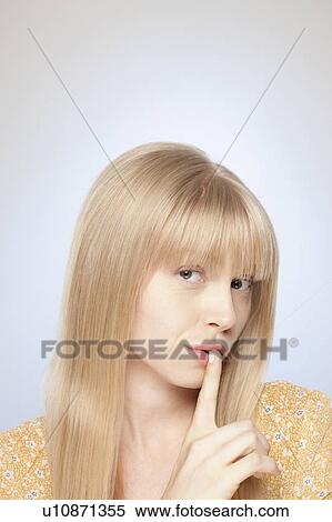 Portrait of woman with finger on her lips View Large Photo Image Stock Photography - Portrait of woman with finger on her lips. Fotosearch