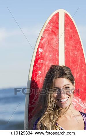 Picture - Portrait of woman with surfboard. Fotosearch