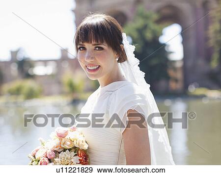 Stock Photo - Portrait of young bride in park. Fotosearch