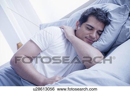 Portrait of young man sleeping in bed View Large Photo Image Stock Photograph - Portrait of young man sleeping in bed. Fotosearch