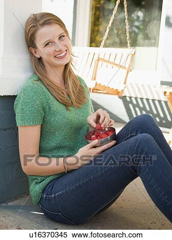 Portrait of young woman eating raspberries View Large Photo Image Stock Photography - Portrait of young woman eating raspberries. Fotosearch
