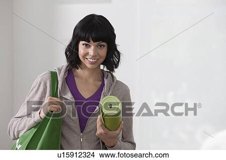Portrait of young woman going for fitness View Large Photo Image Picture - Portrait of young woman going for fitness. Fotosearch