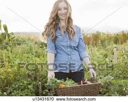 Portrait of young woman harvesting vegetables View Large Photo Image Stock Image - Portrait of young woman harvesting vegetables. Fotosearch