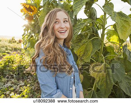 Portrait of young woman in garden View Large Photo Image Stock Photo - Portrait of young woman in garden. Fotosearch