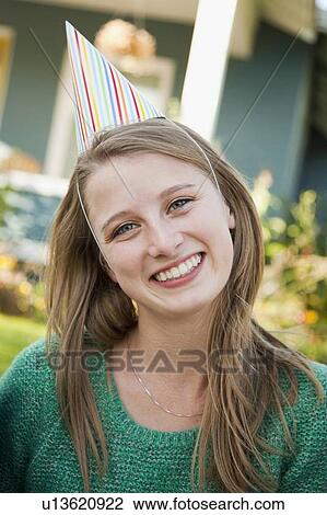 Portrait of young woman in party hat View Large Photo Image Stock Image - Portrait of young woman in party hat. Fotosearch