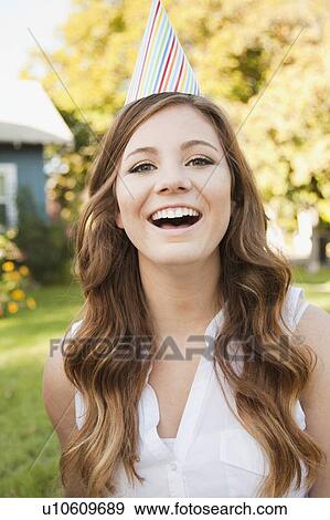 Portrait of young woman in party hat View Large Photo Image Stock Photo - Portrait of young woman in party hat. Fotosearch