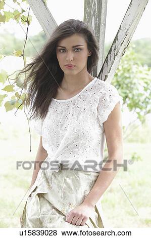 Stock Photo - Portrait of young woman in vineyard. Fotosearch