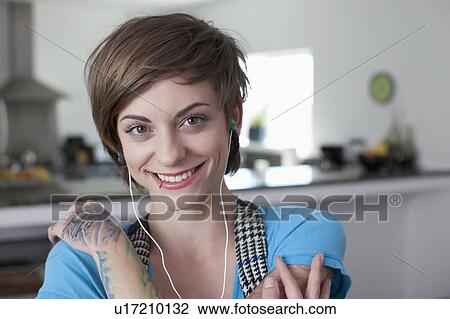 Portrait of young woman listening music View Large Photo Image Stock Image - Portrait of young woman listening music. Fotosearch