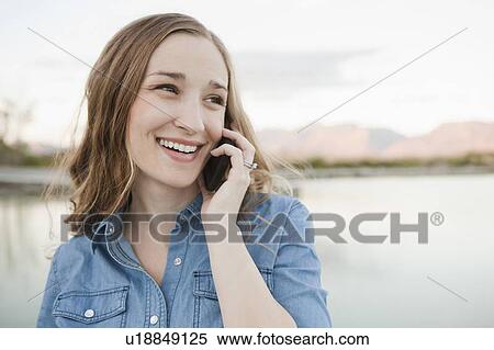 Portrait of young woman talking on phone View Large Photo Image Stock Photography - Portrait of young woman talking on phone. Fotosearch