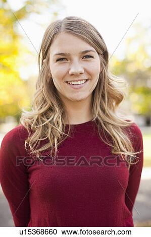Stock Image - Portrait of young woman toothy smiling. Fotosearch