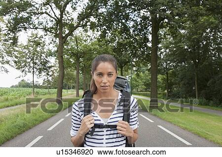 Portrait of young woman with backpack View Large Photo Image Stock Image - Portrait of young woman with backpack. Fotosearch