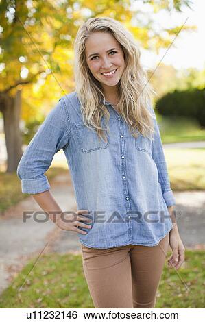 Portrait of young woman with hand on hop View Large Photo Image Stock Photograph - Portrait of young woman with hand on hop. Fotosearch