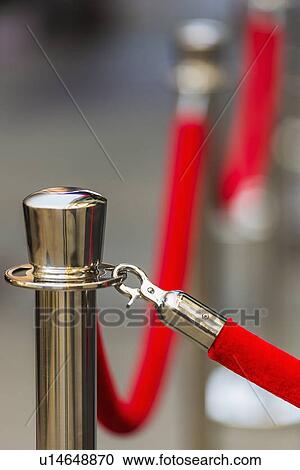 Stock Image - Red rope and stanchion. Fotosearch