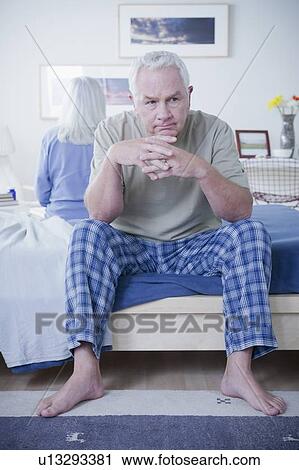 Senior couple after quarrel sitting on bed View Large Photo Image Stock Image - Senior couple after quarrel sitting on bed. Fotosearch