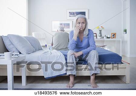 Senior couple after quarrel sitting on bed View Large Photo Image Stock Photograph - Senior couple after quarrel sitting on bed. Fotosearch