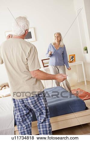 Stock Photo - Senior couple dancing in bedroom. Fotosearch