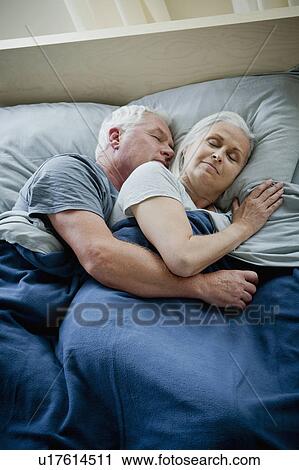Stock Image - Senior couple embracing and sleeping. Fotosearch