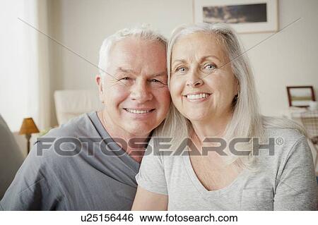 Senior couple sitting on bed in close embrace View Large Photo Image Stock Photograph - Senior couple sitting on bed in close embrace. Fotosearch