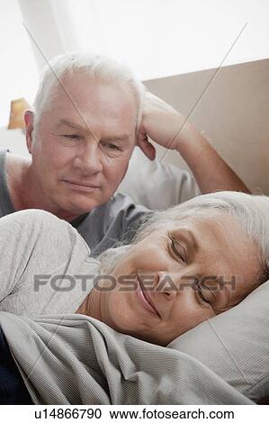 Senior man looking at sleeping wife in bed View Large Photo Image Stock Image - Senior man looking at sleeping wife in bed. Fotosearch