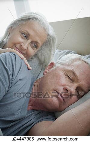 Senior woman looking at sleeping husband View Large Photo Image Stock Photography - Senior woman looking at sleeping husband. Fotosearch