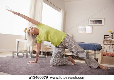 Senior woman practicing yoga View Large Photo Image Stock Photo - Senior woman practicing yoga. Fotosearch