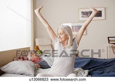Senior woman stretching after waking up View Large Photo Image Stock Image - Senior woman stretching after waking up. Fotosearch