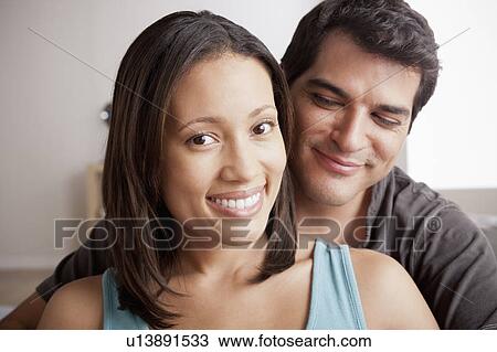 Stock Image - Smiling couple in close embrace. Fotosearch