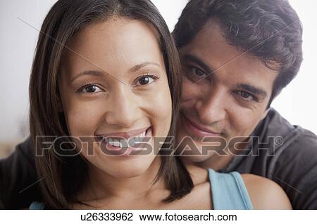 Stock Image - Smiling couple in close embrace. Fotosearch