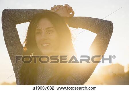 Smiling woman at sunset View Large Photo Image Stock Image - Smiling woman at sunset. Fotosearch