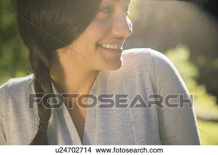 Picture - Smiling woman outdoors. Fotosearch